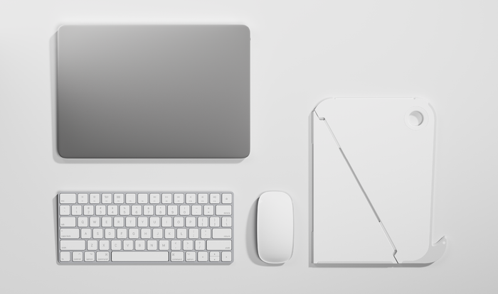 Vue de dessus d'un support d'ordinateur portable Oripura blanc de Herman Miller, posé sur une table blanche à côté d'un ordinateur portable, d'un clavier et d'une souris.
