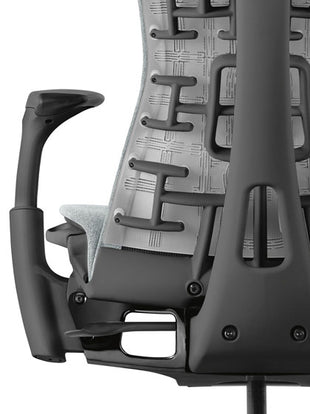 Rear view of a graphite Aeron office chair, showing back support and adjustable arms.