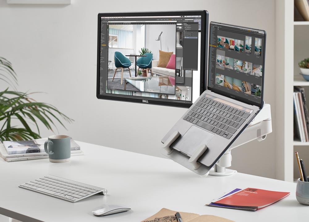 Bras à double écran Lima blanc de CBS avec support d'ordinateur portable blanc, montrant l'écran d'ordinateur et le support d'ordinateur portable.