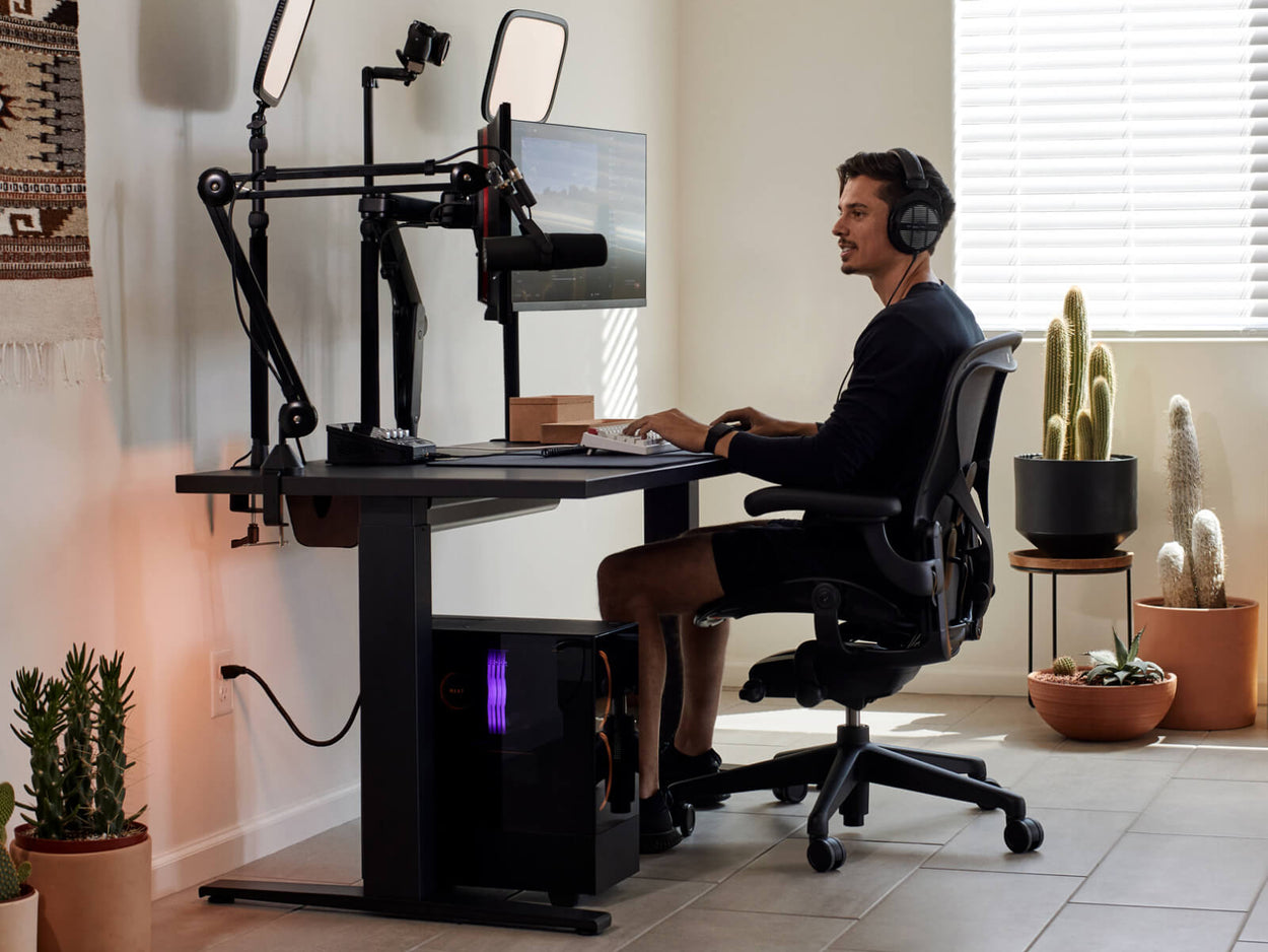 Le joueur Xaryu en train de jouer sur son installation Herman Miller, composé d'un fauteuil de jeu Aeron, d'un bureau de jeu Nevi et de deux bras pour double écran Ollin.