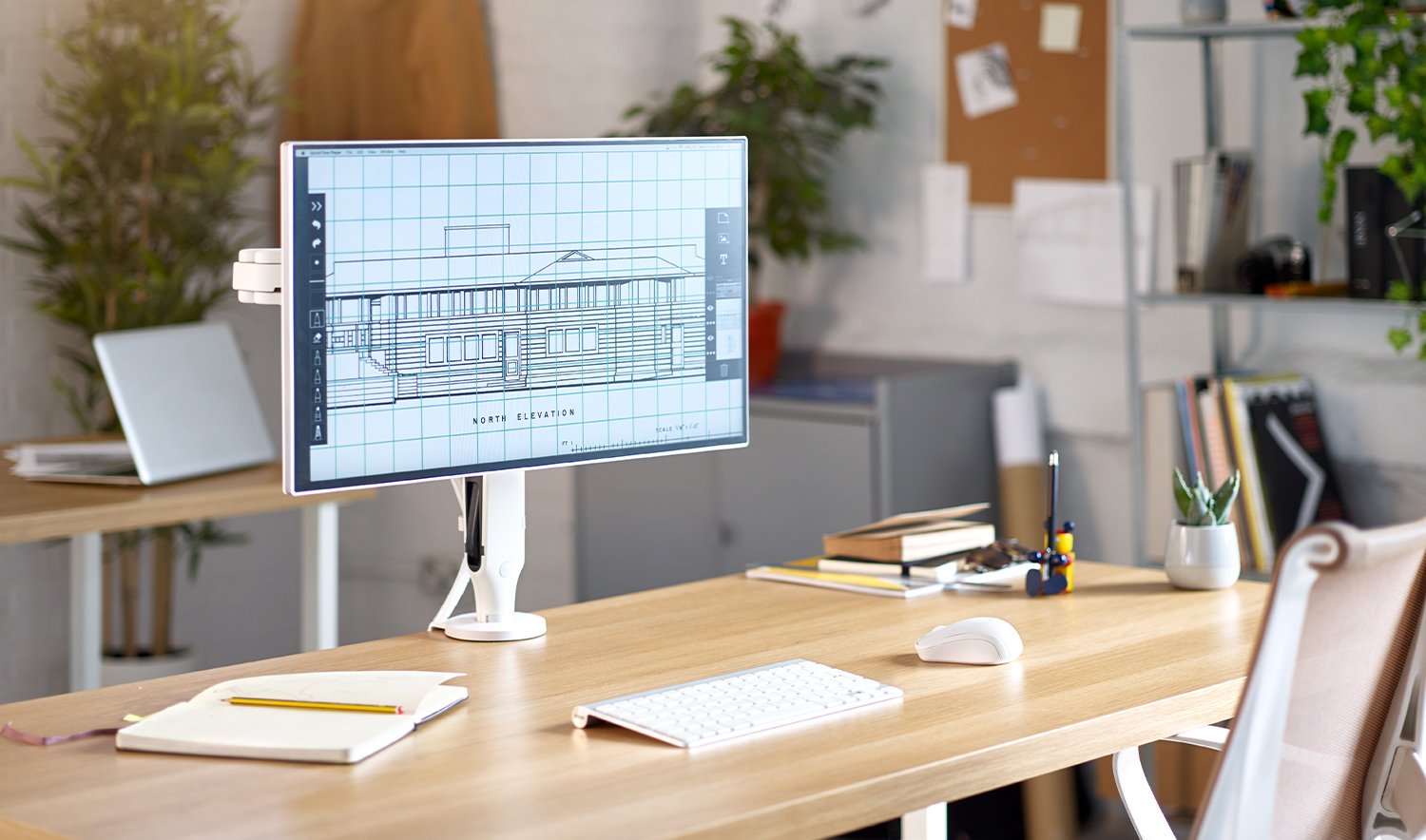 White Ollin monitor arm in an office setting